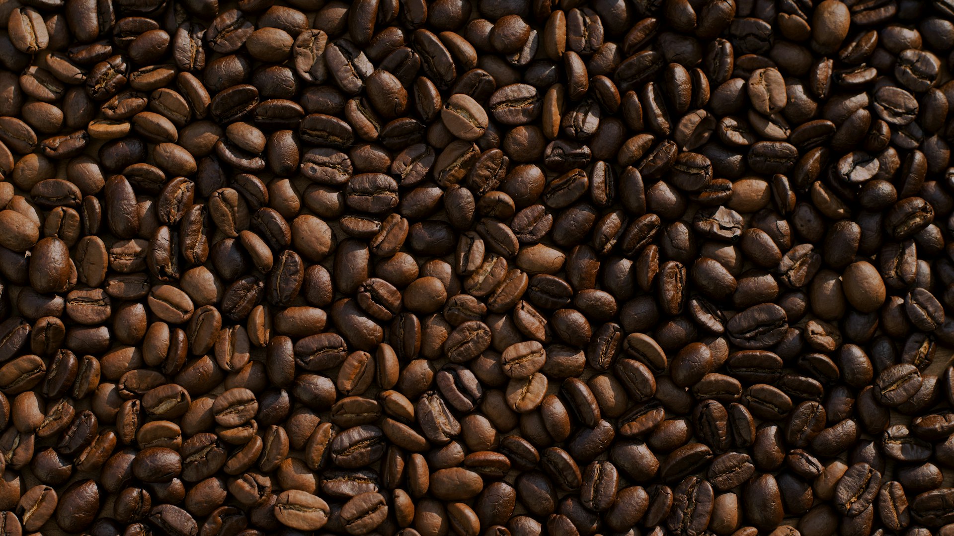 Fresh coffee beans and a steaming cup